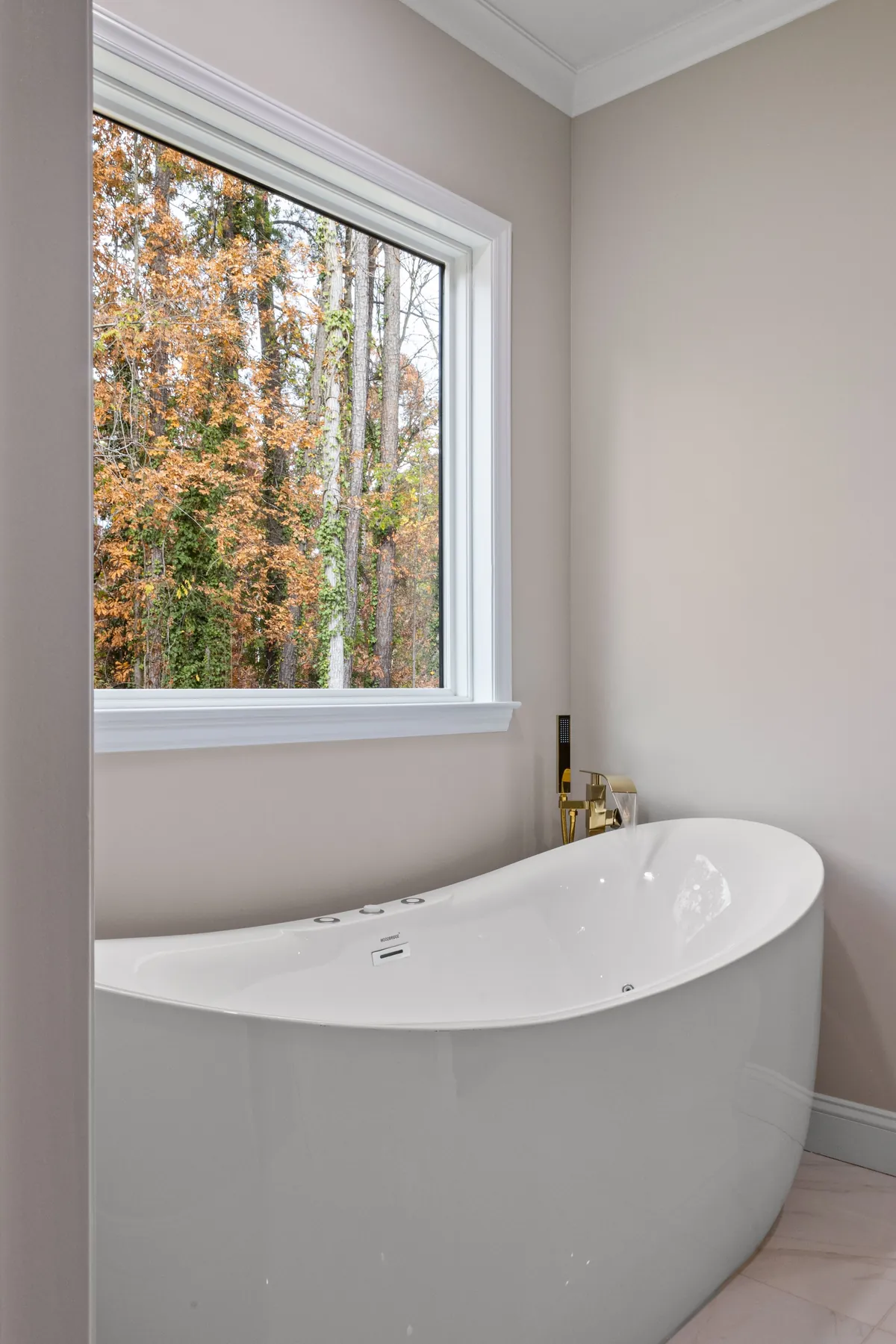 Remodeled master bathroom with a freestanding soaking tub