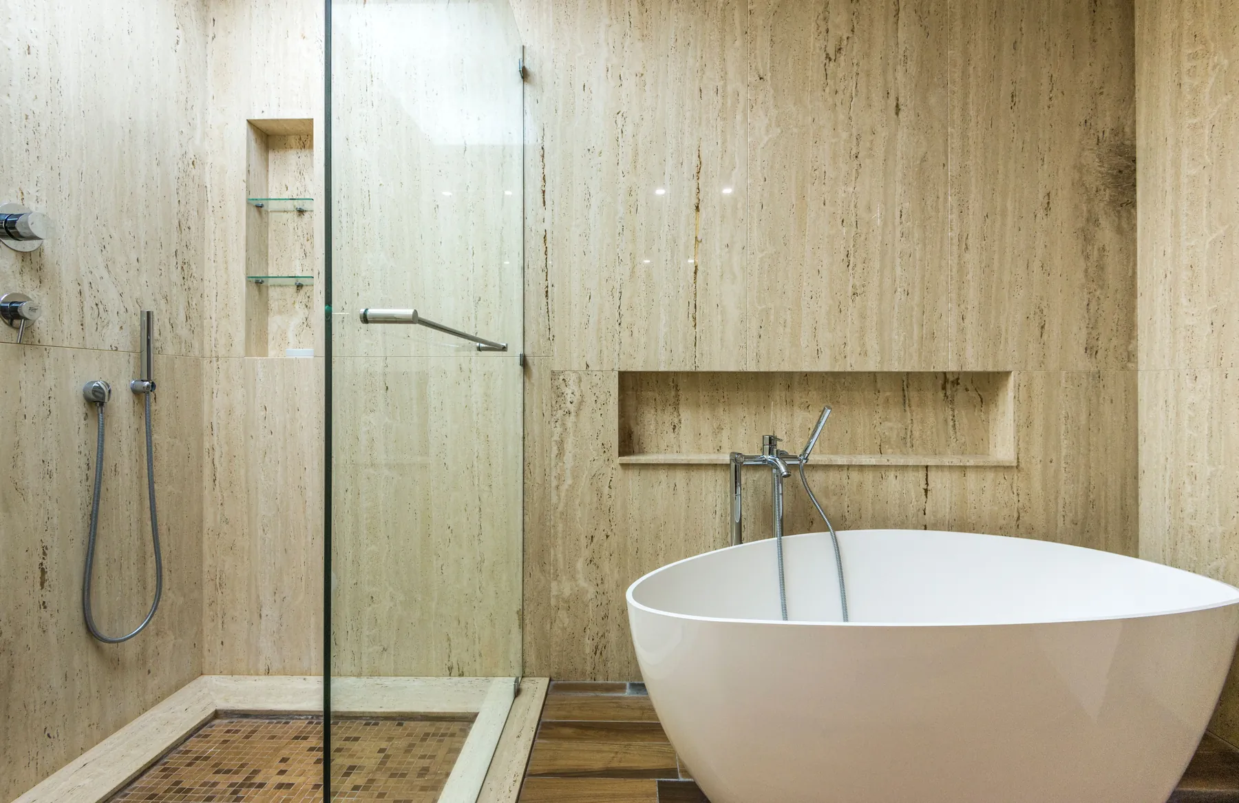 Side-by-side comparison of a bathtub and a converted walk-in shower in the same bathroom footprint